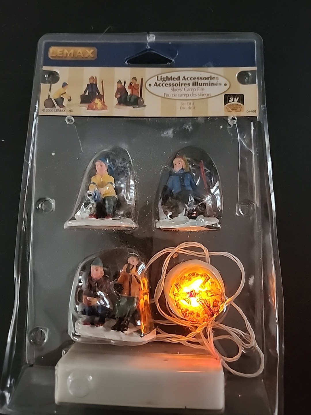 LEMAX Skiers Camp Fire Lighted Holiday Village Train Accent Set Of 4