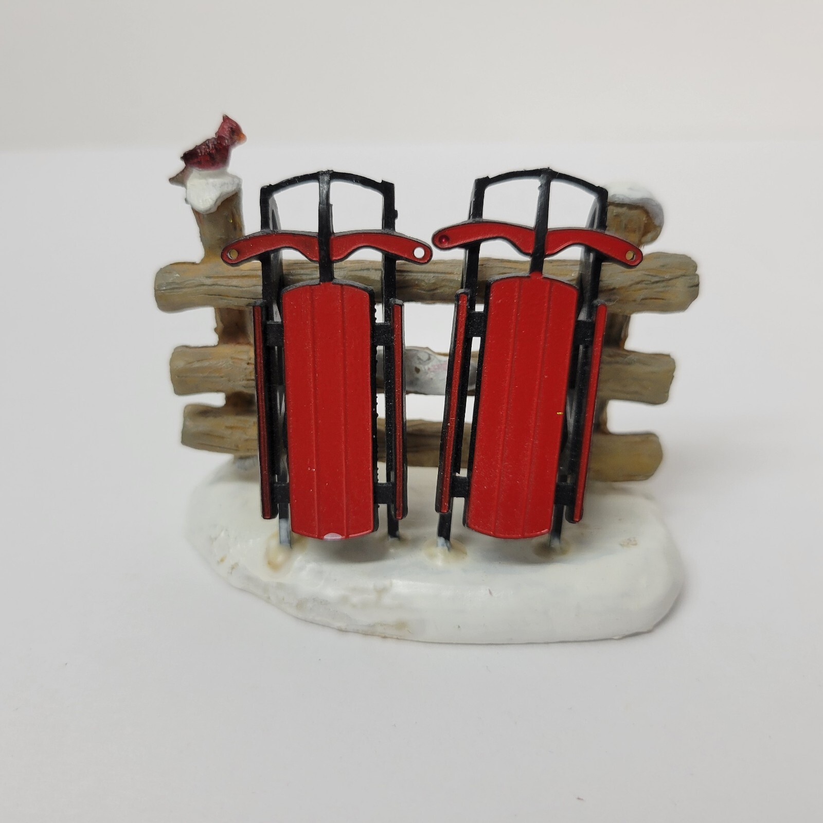 LEMAX Christmas Village Red Sleds In Snow By Fence 3″ Long 2.5″ Tall 1.5″ Wide
