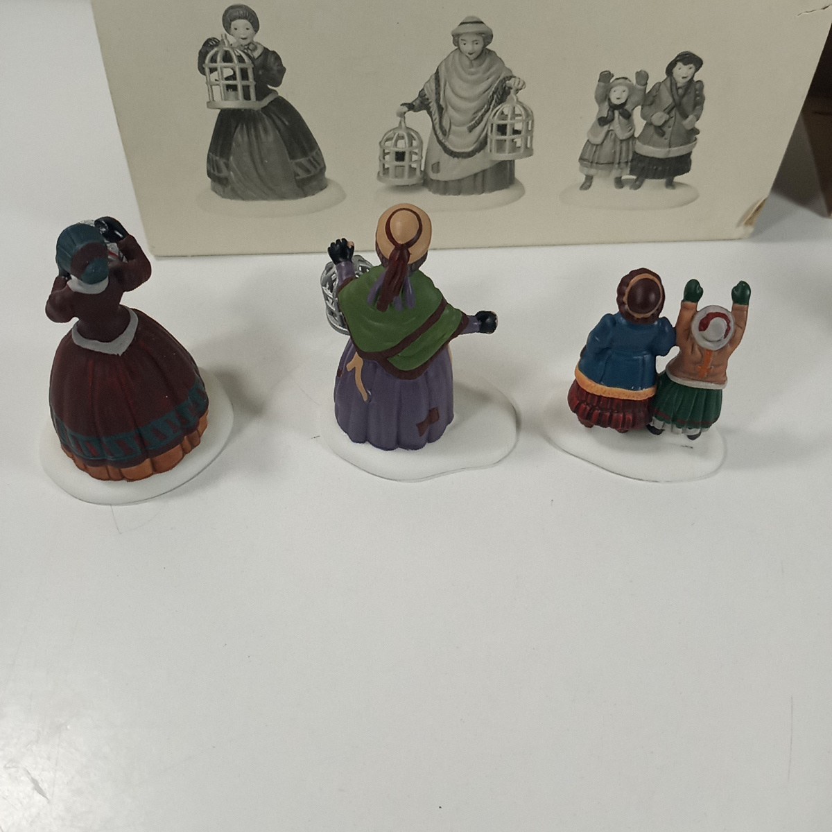 Dept 56 Heritage Village Lot Of 2 The Bird Seller & Welcome Home Figure Sets