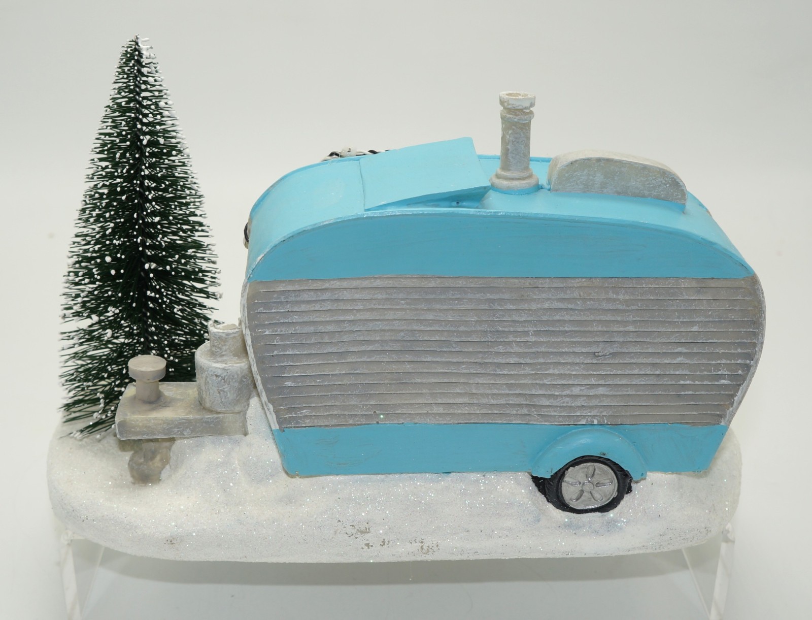St Nicholas Square Camper with Lights and Flickering Campfire Winter Setting