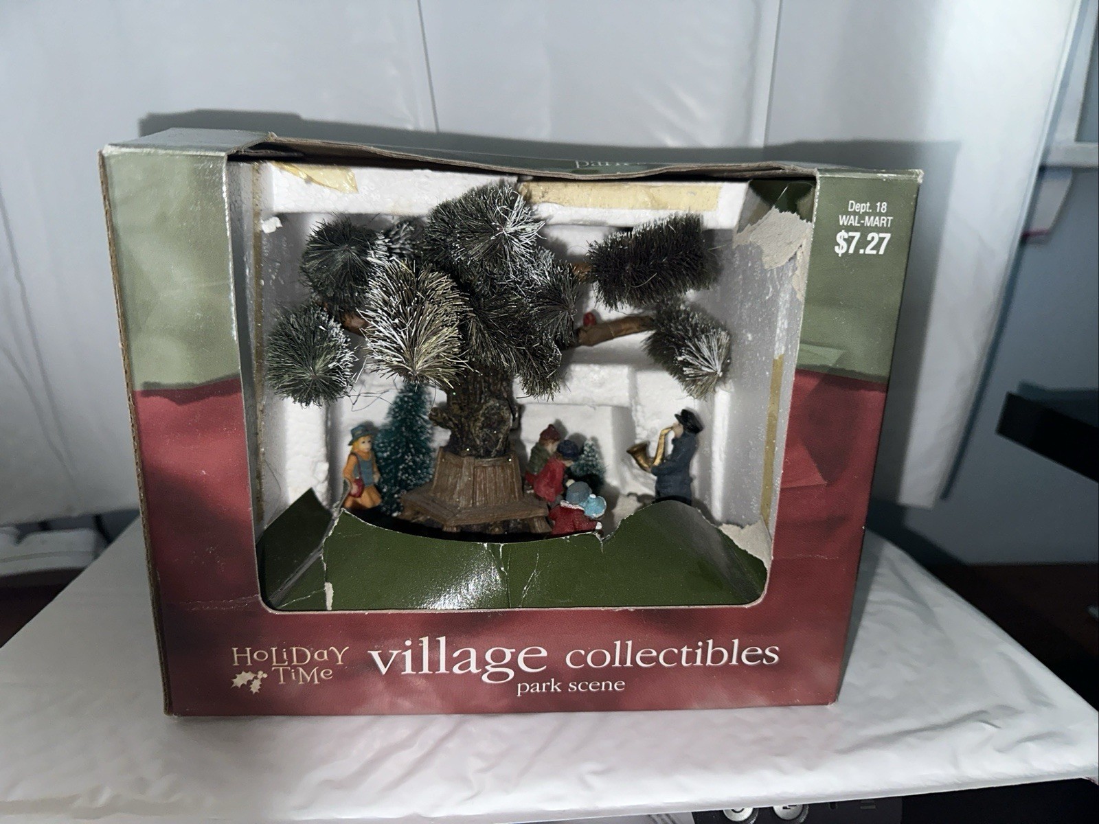 Holiday Time village collectibles park scene. New. Man playing a saxophone.