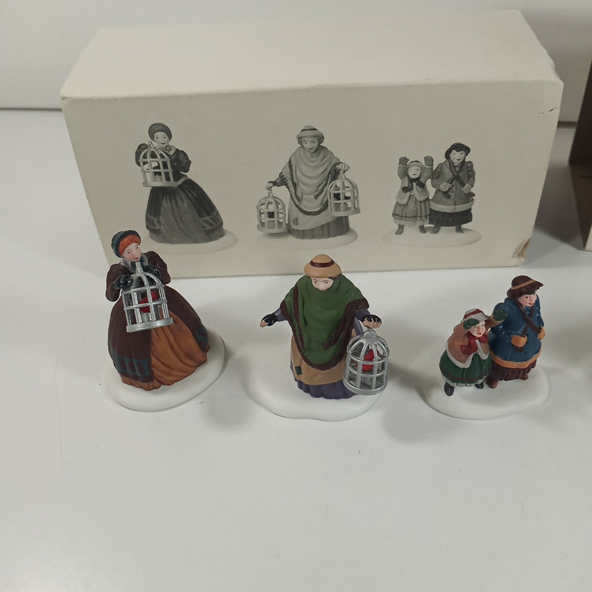 Dept 56 Heritage Village Lot Of 2 The Bird Seller & Welcome Home Figure Sets