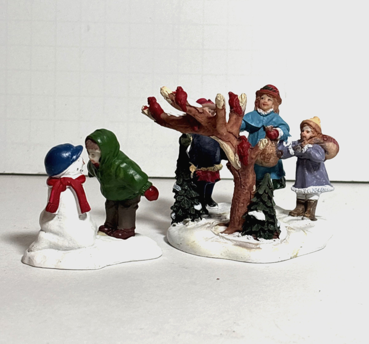 2 Christmas Village Figurines, Resin Figures on Snow Bases, approx 2.5 in high